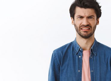 Awkward hospitality worker feigns sadness upon news he must claim Jobsaver stimulus